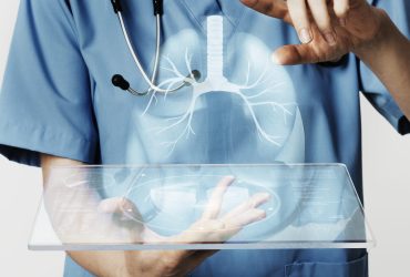 Doctors using transparent tablet with hologram medical technology